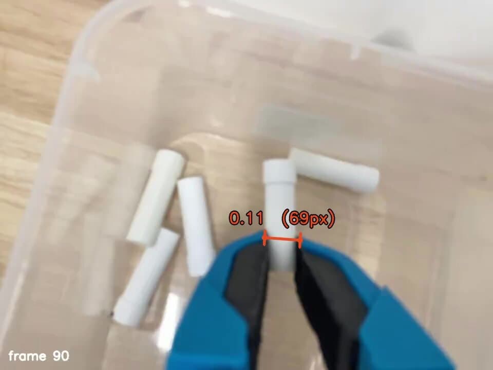 Handheld gripper closing on a tube, with jaw width measured on the frame